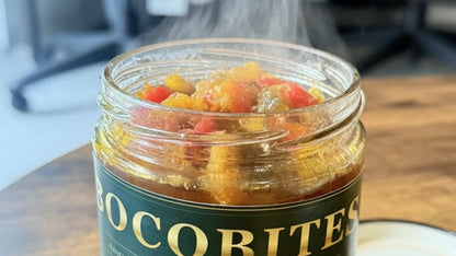 Jar of Cocabites Ratatouille with steam rising, on a wooden surface.